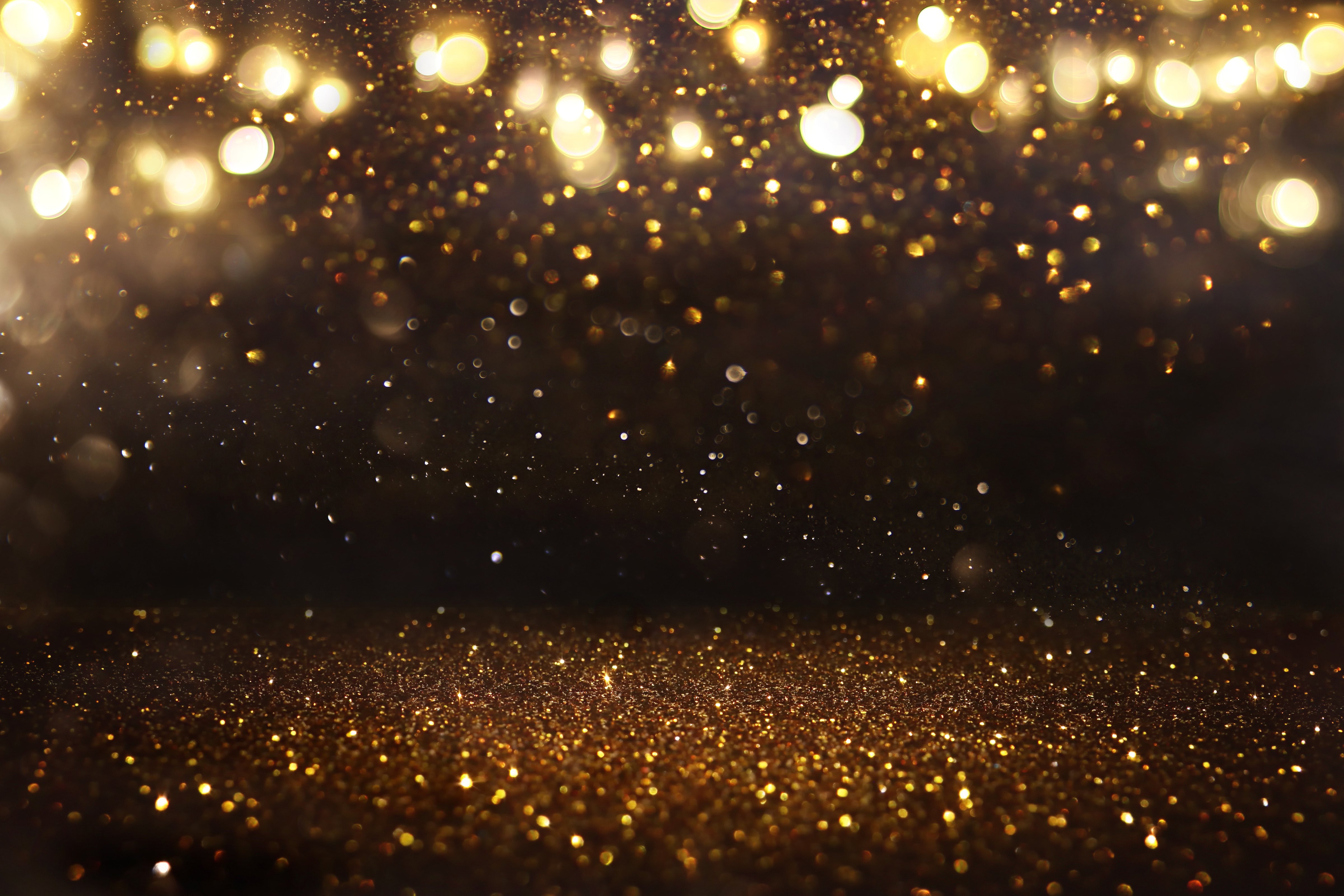 glitter vintage lights background. black and gold. de-focused